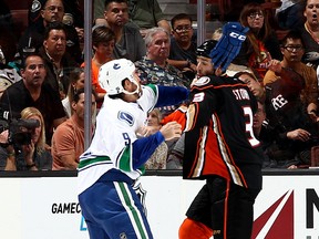 ANAHEIM, CA - OCTOBER 12:  Clayton Stoner #3 of the Anaheim Ducks mixes it up with Brandon Prust #9 of the Vancouver Canucks on October 12, 2015 at Honda Center in Anaheim, California. (Photo by Debora Robinson/NHLI via Getty Images)