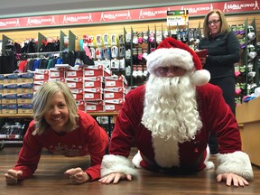 Race director Marie Lashley helps Santa with his planking exercises so the big guy is ready for the Santa Shuffle Fun Run and Elf Walk in Abbotsford on Saturday, Dec. 5. Sumas Way Running Room manager Wendy Jordan-Olive, who keeps an eye on the pair, points out there are other Salvation Army Santa Shuffles in B.C. on the same day — Kamloops, Kelowna, Nanaimo, Quesnel, Vancouver and Victoria.