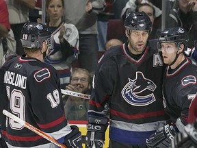 The West Coast Express — Markus Naslund, Todd Bertuzzi and Brendan Morrison (left to right) — celebrate a goal during their heyday with the Vancouver Canucks. (Jeff Vinnick, Getty Images files)