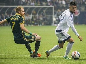 Vancouver Whitecaps midfielder Pedro Morales (right) tries to get around Portland Timbers defender Nat Borchers during their second-leg MLS Western Conference semifinal game at BCPlace Stadium on Sunday. The Caps’ gamble of starting Morales didn’t pay off for the club, which lost 2-0. (Ric Ernst, PNG)