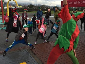 Entertaining Elf Fizzyboots Truffleberry leads the wee elves through some fun warm-ups before their 1K run on Sunday afternoon at Stanley Park.