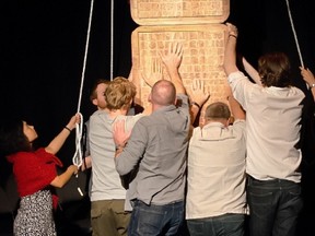 Contact! Unload features the stories of four Afghanistan veterans as they transition back to life in Canada — it's a form of therapy for the men and some of the audience. Photo: Veterans lift up a 'Tribute Pole' to people who have served in the military.