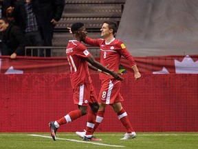 VANCOUVER, BC., November 13, 2015 -- Canada's Will Johnson (8) and Tosaint Rickets (11) celebrate the goal against Honduras during FIFA World Cup action at BC Place Stadium in Vancouver, BC., November 13, 2015.  (Nick Procaylo/PNG)   00040023A   [PNG Merlin Archive]