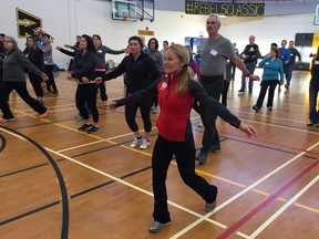 Lynn Kanuka of SportMedBC leads new and returning Sun Run leaders through a couple warm-up exercises at Burnaby Secondary School on Saturday. InTraining clinics get underway this weekend around the province.