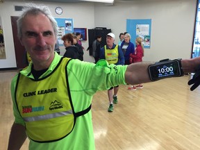 Popular Langley leader Phil Reade, who works with the learn to run stronger group in the Walnut Grove InTraining clinic, shows off his bright timing device before Sunday morning's training session.