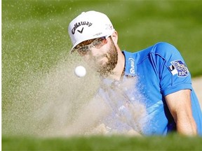 Adam Hadwin hits out of the bunker on the eighth fairway during the final round of the CareerBuilder Challenge golf tournament on the TPC Stadium course at PGA West in La Quinta, Calif., Sunday. The Abbotsford native tied for sixth.