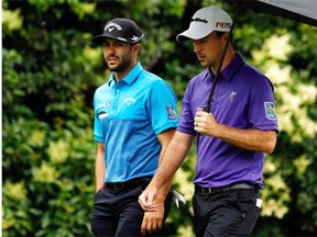 Adam Hadwin and Nick Taylor from Canada walk the fairway during the final round of the Crowne Plaza Invitational at the Colonial Country Club on May 24, 2015 in Fort Worth, Texas.