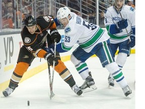 The Anaheim Ducks’ Ryan Getzlaf (left) and the Vancouver Canucks’ Bo Horvat battle for the puck during their NHL game in October in Anaheim, Calif., game the Canucks won 2-1. The teams meet again Monday.
