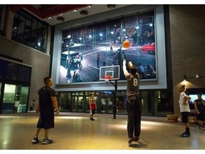 Basketball players shoot the ball before the start of a pickup game in the lobby of the Woodward’s Building in Vancouver on Jan. 11.