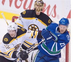 Boston Bruins defenceman Zach Trotman tries to clear Vancouver Canucks winger Daniel Sedin from in front of Boston Bruins goaltender Tuukka Rask during the second period of Saturday’s game at Rogers Arena.