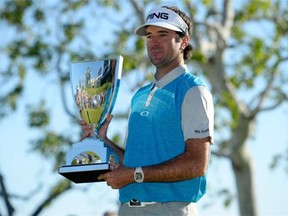 Bubba Watson poses with the trophy after putting in to win on the 18th hole during the final round of the Northern Trust Open at Riviera Country Club on February 21, 2016 in Pacific Palisades, California.