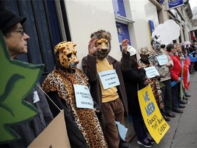Activists form a human chain during a protest ahead of the 2015 Paris Climate Conference, in Paris, Sunday, Nov. 29, 2015. More than 140 world leaders are gathering around Paris for high-stakes climate talks that start Monday, and activists are holding marches and protests around the world to urge them to reach a strong agreement to slow global warming. (AP Photo/Christophe Ena)
