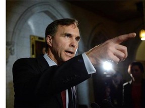 Minister of Finance Bill Morneau makes an announcement in foyer of the House of Commons on Parliament Hill in Ottawa on Friday, December 11, 2015. THE CANADIAN PRESS/Sean Kilpatrick