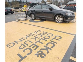 Darius Tsui places groceries into the trunk of a car at Real Canadian Superstore in Vancouver. Parent company Loblaw is launching an online shopping option at four B.C. stores that allows shoppers to order their food online and then collect their order at the store.