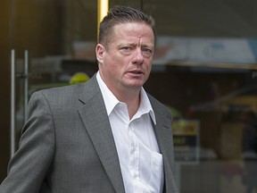 File: Rodney Wharram walks out of B.C. Securities Commission in Vancouver, BC, April 7, 2014.
