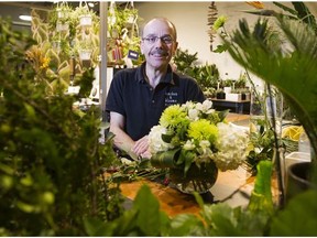 Robin Schafer of Bunches and Blooms poses for a photo in his store inside the River Market at New Westminster Quay in New Westminster, BC, November, 3, 2015.