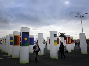 A man walks next to the entrance at the COP21, the United Nations Climate Change Conference Wednesday, Dec. 2, 2015 in Le Bourget, north of Paris. (AP Photo/Christophe Ena)