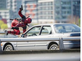 A character from the movie Deadpool, starring Ryan Reynolds, is seen running and jumping over cars on the Georgia viaduct in Vancouver, April 7, 2015.