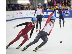 Charles Hamelin celebrates a gold medal in men's relay in front of Tianyu Han, of China, at the ISU World Cup short-track speed skating event in Toronto.