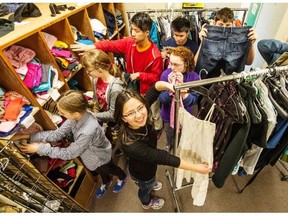 Sir Charles Tupper Secondary pupil Emma Takahashi (foreground) and her fellow Charlie’s Closet volunteers go over clothing to be given away.