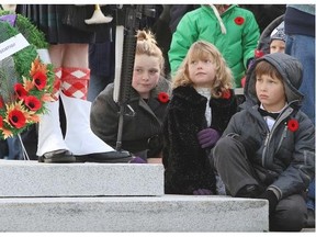 Children watch wreath-laying during Remembrance Day ceremonies. In New Westminster, efforts are being made to teach children about veterans and Canada’s war history through activities at the cemetery.