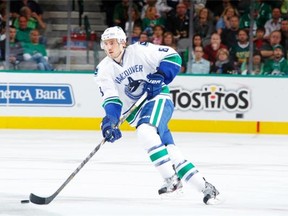 Christopher Tanev #8 of the Vancouver Canucks skates against the Dallas Stars at the American Airlines Center on October 21, 2014 in Dallas, Texas.