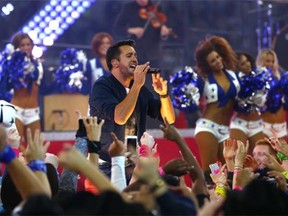 Country singer Luke Bryan played his hits while the Dallas Cowgirls danced along during halftime of the Thanksgiving Day game between the Carolina Panthers and the Cowboys at AT&T Stadium on Thursday.