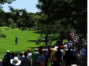 A crowd watches as Sean O’Hair makes an approach shot on the picturesque 16th hole at Glen Abbey Golf Club during the 2008 RBC Canadian Open in Oakville, Ont.