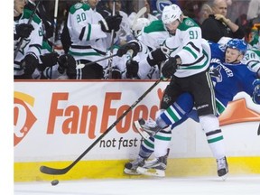 Dallas Stars’ Tyler Seguin, left, and Vancouver Canucks’ Ronalds Kenins, of Latvia, collide during the first period of an NHL hockey game in Vancouver, B.C., on Thursday December 3, 2015.