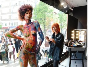 Dany Sanz, founder of  Make-Up Forever beauty brand, bodypainting in Debenhams’s shop window in London.