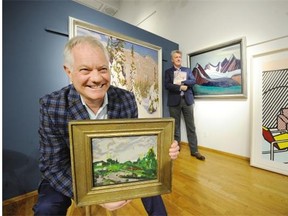 David Heffel (left) holds Tom Thomson’s After The Storm, along with Lawren Harris’s Winter Land and Mountain and Glacier beside Robert Heffel (in back), all part of the upcoming Heffel auction.