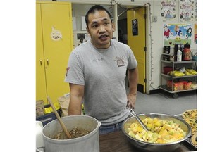 Ray Deguzman prepares food for the KidSafe program at Queen Alexandra elementary school in Vancouver.