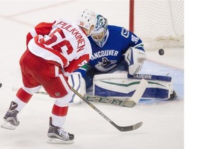 Detroit Red Wings #56 Teemu Pulkkinen scores on Vancouver Canucks goalie Ryan Miller  in the third period of a regular season NHL hockey game at the Rogers arena, Vancouver. October 24 2015.