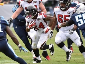 Devonta Freeman #24 of the Atlanta Falcons rushes against the Tennessee Titans during the first half at Nissan Stadium on October 25, 2015 in Nashville, Tennessee.