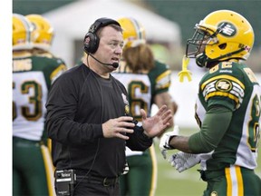 Edmonton Eskimos head coach Chris Jones talks with AJ Guyton during a preseason game last month. Formerly Calgary’s defensive co-ordinator, Jones left under controversial circumstances, taking the same position in Toronto. So there is intrigue with him going against the team he left.