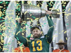 Edmonton Eskimos quarterback Mike Reilly hoists the Grey Cup after his teams win over the Ottawa Redblacks during the 103rd Grey Cup in Winnipeg, Man., Sunday, Nov. 29, 2015.