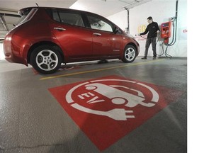 An electric car is plugged into a charging station at Vancity’s office in Vancouver. Electric vehicles accounted for 1,200 of the 1.3 million passenger vehicles on Lower Mainland roads in 2014.