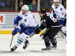 Emerson Etem of the Vancouver Canucks (left) skates against the New York Islanders during the first period at their NHL game at Barclays Center in the Brooklyn borough of New York City on Sunday.