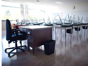 A empty teachers desk is pictured at the front of a empty classroom at Mcgee Secondary school in Vancouver on Sept. 5, 2014.
