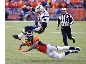 New England Patriots quarterback Tom Brady is tackled by Denver Broncos cornerback Aqib Talib (21) during the first half the NFL football AFC Championship game between the Denver Broncos and the New England Patriots, Sunday, Jan. 24, 2016, in Denver.
