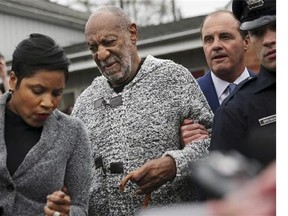 Actor and comedian Bill Cosby is helped as he leaves a court appearance where he faced a felony charge of aggravated indecent assault Wednesday, Dec. 30, 2015, in Elkins Park, Pa. Cosby was arrested and charged Wednesday with drugging and sexually assaulting a woman at his home in January 2004. (AP Photo/Mel Evans)
