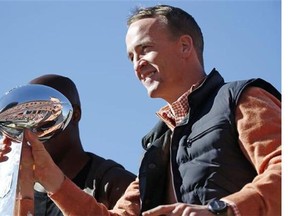 Denver Broncos quarterback Peyton Manning holds the Lombardi Trophy during a parade for the NFL's Super Bowl champions last Tuesday in Denver, Colo.