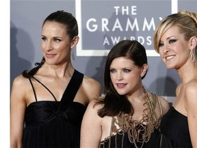 FILE - In this Feb. 11, 2007, file photo, the Dixie Chicks, Emily Robison, left, Natalie Maines, center, and Martie Maguire, who earned five Grammy nominations, arrive for the 49th Annual Grammy Awards in Los Angeles. The Dixie Chicks are ready to party in the USA with a summer 2016 tour. The Grammy-winning group will kick off its “DCX MMXVI World Tour” on June 1, 2016, in Cincinnati. It wraps in Los Angeles on Oct. 10, 2016. The group will visit more than 40 cities, including New York, Chicago, San Francisco, Detroit, Dallas and Toronto. The Dixie Chicks' North American tour will follow the group's European tour that begins in April. (AP Photo/Matt Sayles, File)