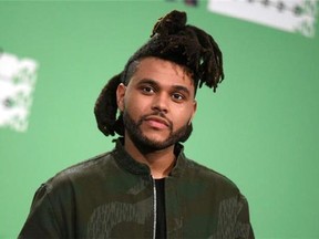 The Weeknd poses in the press room at the MTV Video Music Awards in Los Angeles, Aug.30, 2015. After dominating the Billboard charts for many months and landing an Oscar nomination and seven Grammy nods, the Weeknd is now being recognized on home turf with a leading six Juno Award nominations.THE CANADIAN PRESS/Photo by Richard Shotwell/Invision/AP,