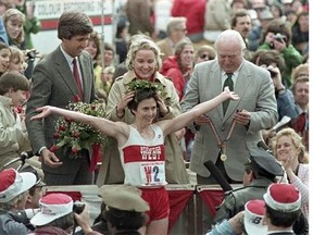 FILE - In this April 19, 1983, file photo, Joan Benoit receives her laurel wreath and reacts to cheering crowds after winning the Boston Marathon in record time for the women's division, in Boston. Massachusetts Lt. Gov. John Kerry, left in red tie, stands behind her. Benoit also won the women's division of the race in 1979. The first feature-length documentary film highlighting historical moments of the nation’s oldest marathon is in the works, tentatively set to premiere in April 2017 in conjunction with the 121st running of the race. (AP Photo/File)