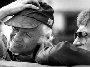 In this March 30, 1983, file photo, cinematographer Haskell Wexler adjusts his cap as he and director Blake Edwards, right, look over a wall during the filming of The Man Who Loved Women. Wexler, the two-time Oscar-winning cinematographer and prominent social activist, died Sunday, Dec. 27, 2015. He was 93.