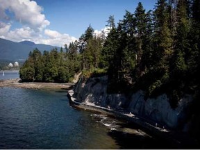 People are caught in rays of sunlight as they run and walk along the Stanley Park seawall near Siwash Rock in Vancouver, B.C., on Sunday August 25, 2013. Vancouver’s West End has won the title of Great Neighbourhood in the fifth annual Great Places of Canada competition, with a Kelowna park rounding out the top three grand prizes. Jaspal Marwah, one of the seven jurors, said the West End was chosen because the area is safe and inviting for residents to walk and bike to work, to access local businesses and to explore Vancouver’s beaches, trails and Stanley Park.