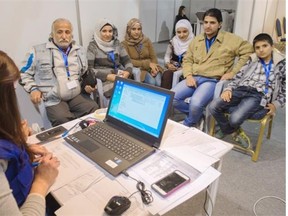 A family of Syrian refugees is interviewed by authorities in hope of being approved for passage to Canada at a refugee processing centre in Amman, Jordan.