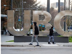 Files: A man on a skateboard and a young woman pass large letters spelling out UBC at the University of British Columbia in Vancouver, B.C., on Sunday, November 22, 2015.