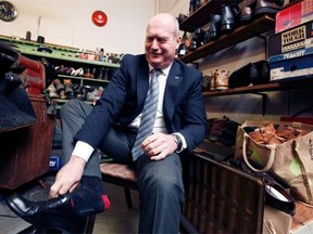 B.C. Finance Minister Michael de Jong tries on his newly soled Budget 2016 dress shoes Monday at Olde Town Shoe Repair in Victoria.